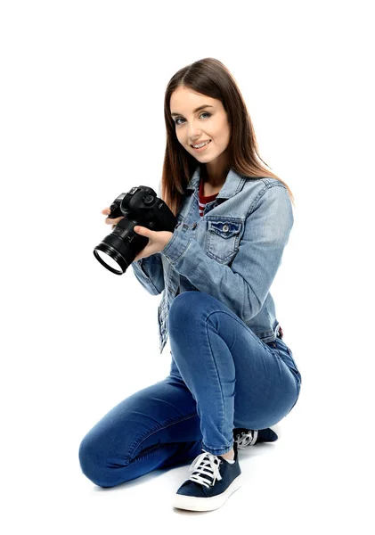 Young female photographer on white background — Stock Photo, Image