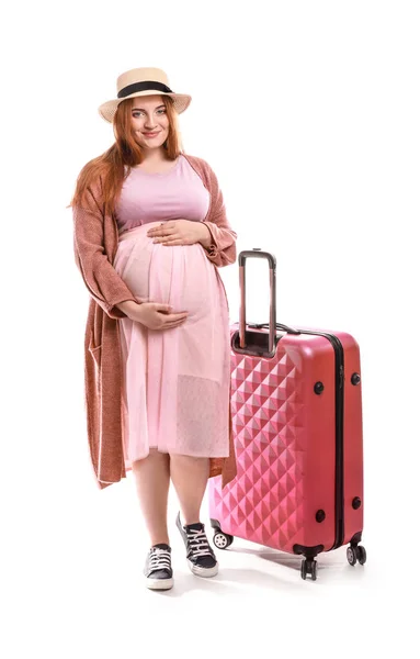 Beautiful pregnant woman with suitcase on white background