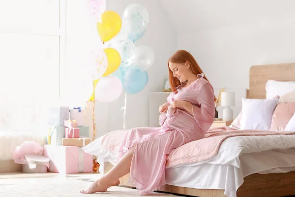Красивая беременная женщина сидит на кровати — стоковое фото