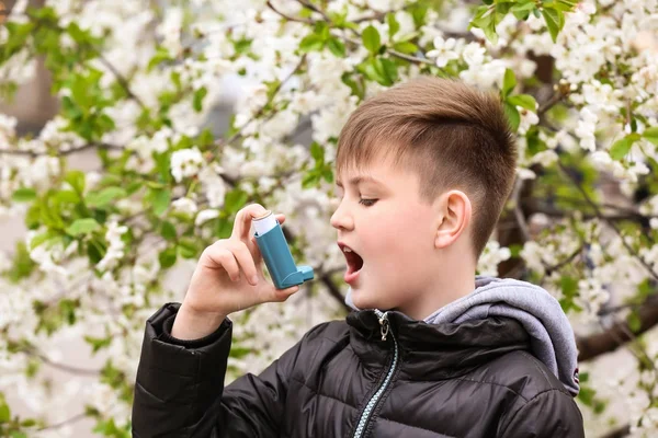 Boy with inhaler having asthma attack on spring day — Stock Photo, Image