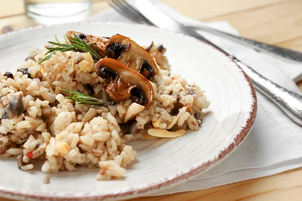 Plate with tasty risotto on wooden table — Stock Photo, Image