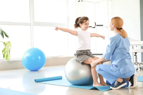 Physiotherapist working with little girl in rehabilitation center — Stock Photo, Image