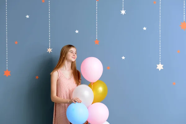 Linda adolescente con globos de aire en el fondo de color — Foto de Stock