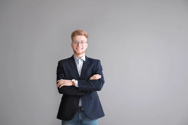 Portrait of businessman on grey background — Stock Photo, Image