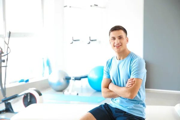 Young male physiotherapist in rehabilitation center — Stock Photo, Image