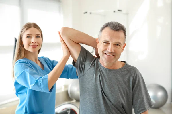 Physiotherapeutin arbeitet mit erwachsenen Patienten im Reha-Zentrum — Stockfoto