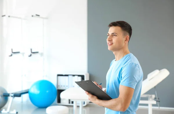 Young male physiotherapist in rehabilitation center — Stock Photo, Image