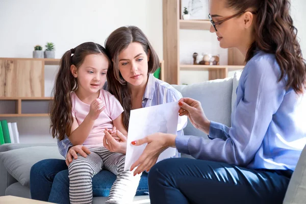 Female psychologist working with family in office