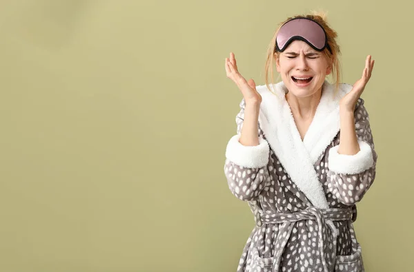 Stressed woman with sleep mask on color background — Stock Photo, Image