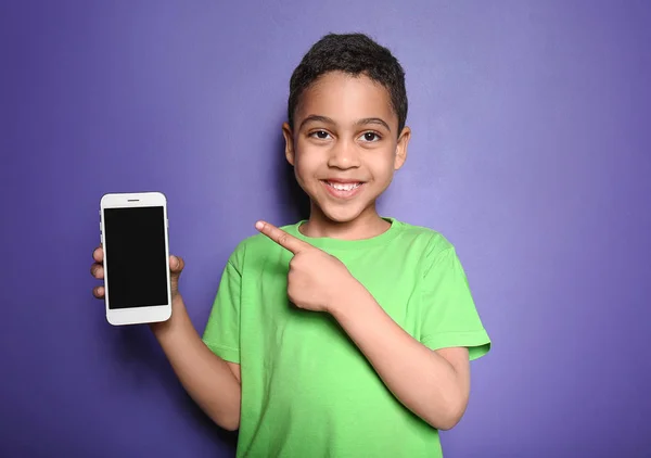 Χαριτωμένο μικρό αγόρι με το κινητό τηλέφωνο στο φόντο χρώμα — Φωτογραφία Αρχείου