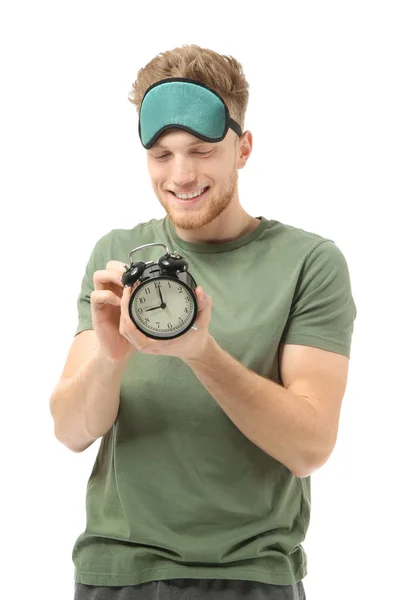 Handsome man with sleep mask and alarm clock on white background — Stock Photo, Image
