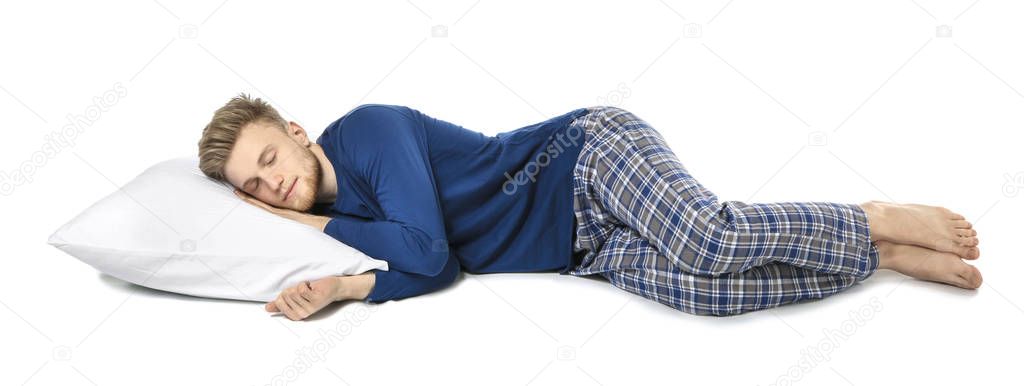 Handsome sleeping man with pillow on white background