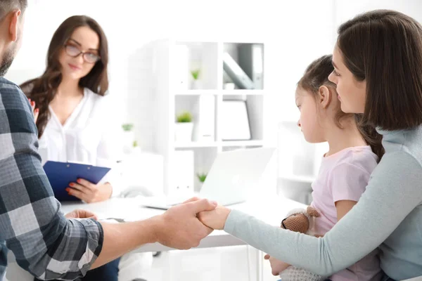 Family visiting psychologist in office