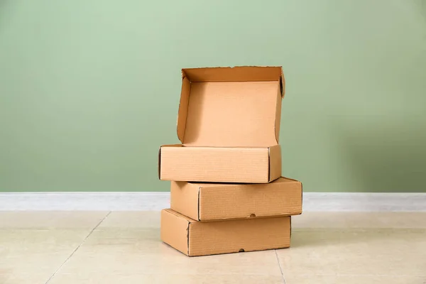 Cardboard boxes near color wall — Stock Photo, Image