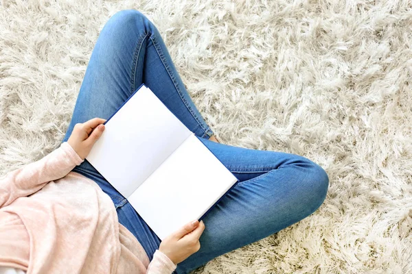 Beautiful young woman reading book at home, top view — Stock Photo, Image