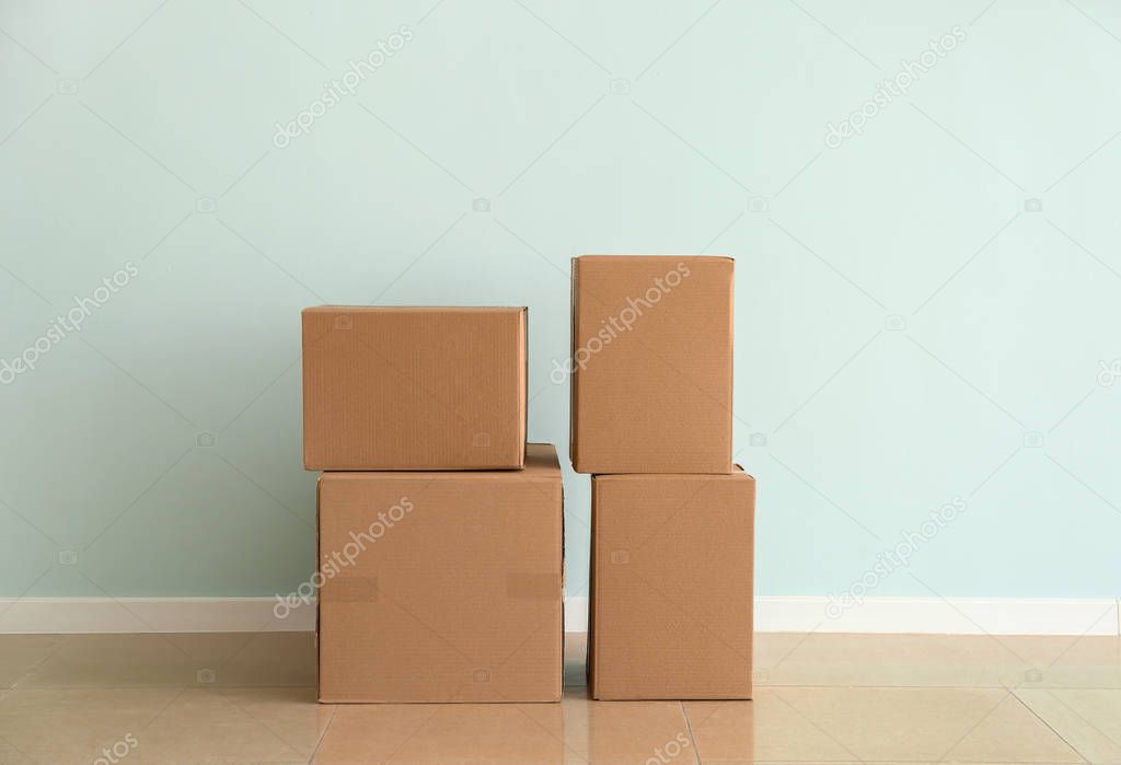Cardboard boxes near light wall