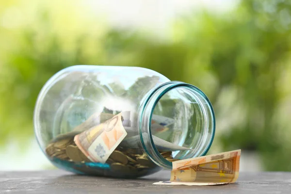 Jar with money on table