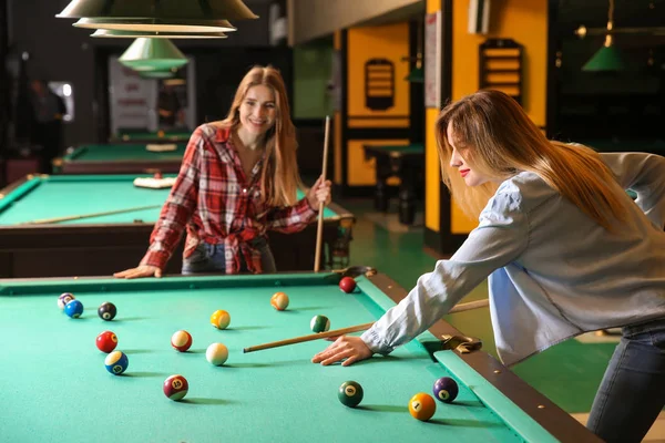 Young women playing billiard in club — Stock Photo, Image