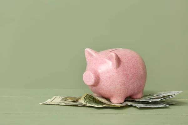 Piggy bank with money on color background — Stock Photo, Image