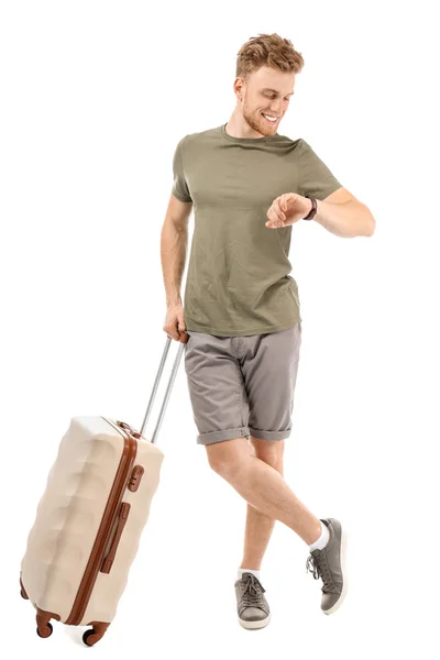 Young tourist looking at his watch against white background — Stock Photo, Image