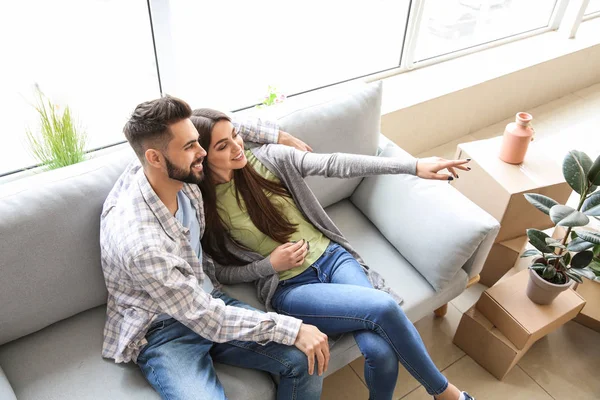 Young couple sitting in their new house — Stock Photo, Image