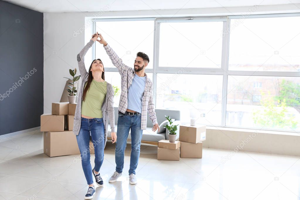 Young couple dancing in their new house