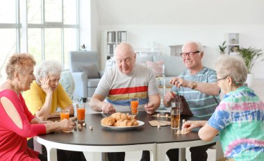 Group of senior people spending time together in nursing home clipart