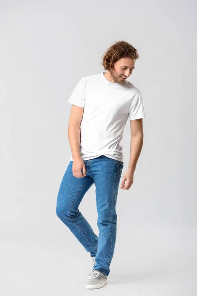 Stylish young man in jeans on white background — Stock Photo, Image