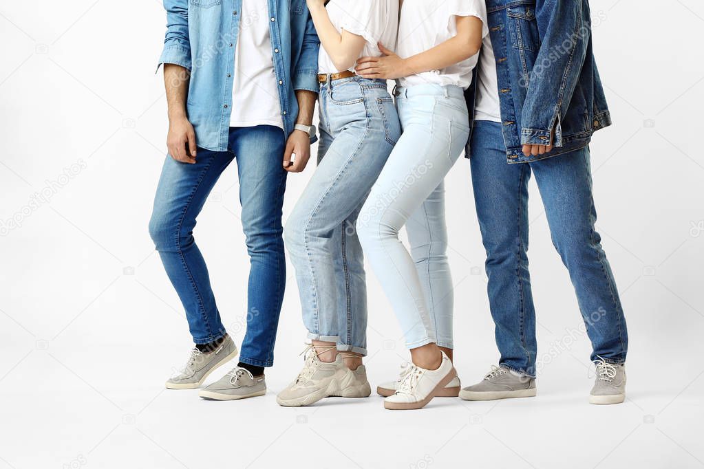 Stylish young people in jeans clothes on white background