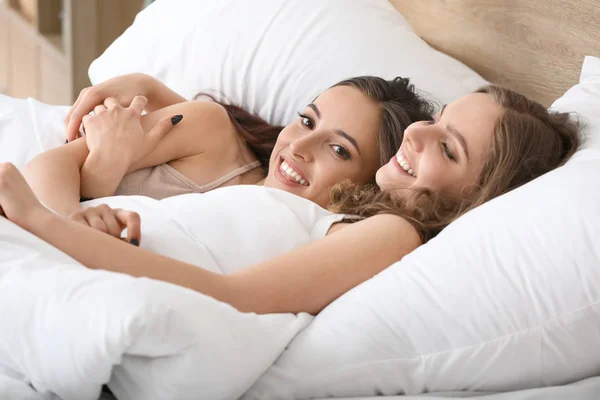 Heureux lesbiennes couple couché dans lit — Photo