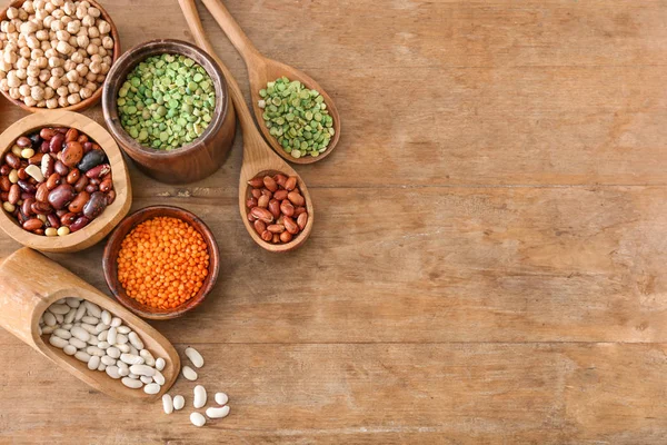 Assortment of legumes on wooden table — Stock Photo, Image