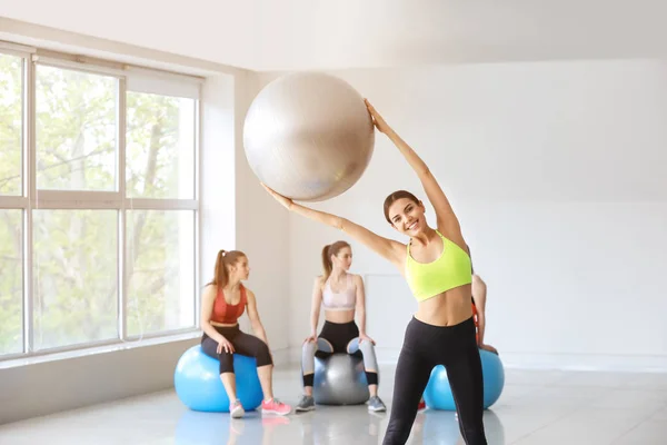Young sporty woman doing exercises with fitball in gym — Stock Photo, Image