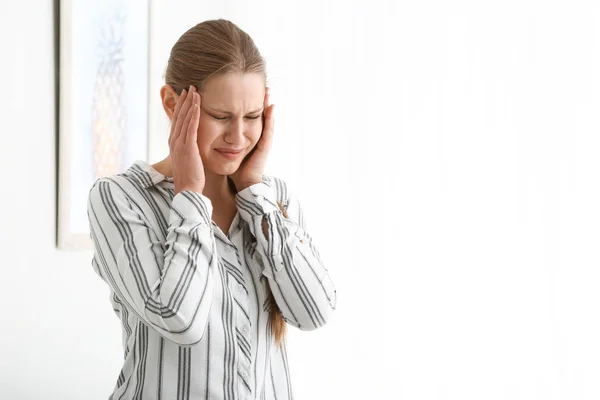 Young woman suffering from headache at home — Stock Photo, Image