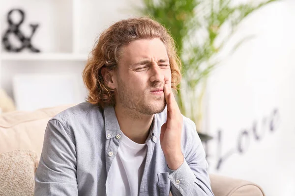 Young man suffering from toothache at home — Stock Photo, Image