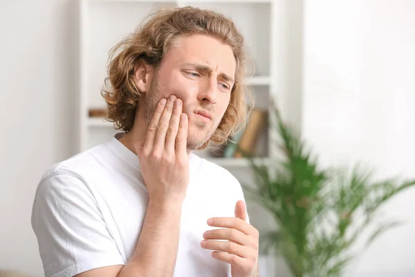 Young man suffering from toothache at home — Stock Photo, Image