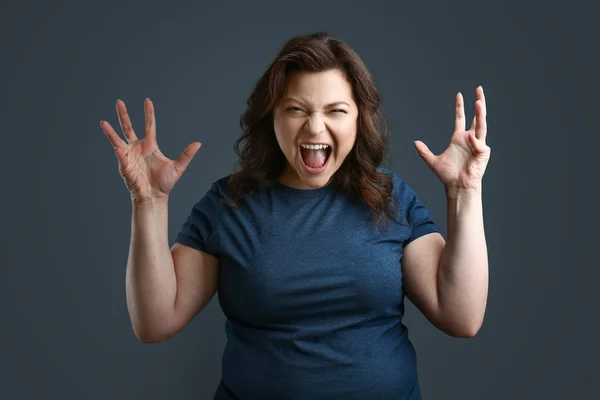 Screaming plus size woman on grey background — Stock Photo, Image