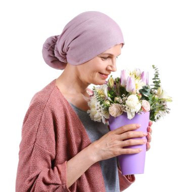 Mature woman after chemotherapy with bouquet of flowers on white background clipart