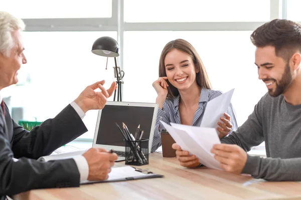 Couple meeting with notary public in office