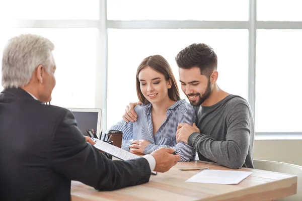 Couple meeting with notary public in office