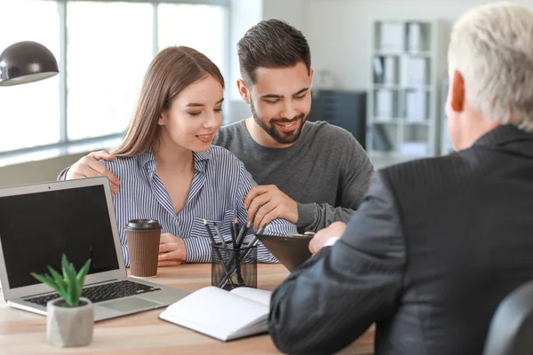 Couple meeting with notary public in office