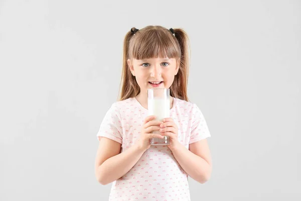 Cute little girl with glass of milk on white background — Stock Photo, Image