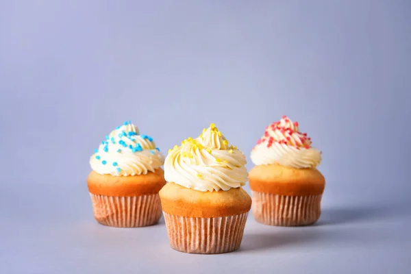 Tasty Birthday cupcakes on grey background — Stock Photo, Image