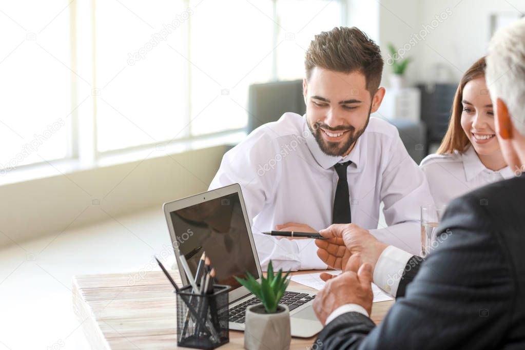 Couple meeting with notary public in office