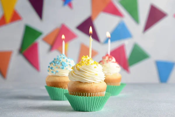 Tasty Birthday cupcakes on grey table — Stock Photo, Image