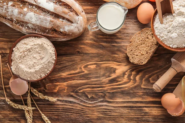 Flour with products and bread on wooden background — Stock Photo, Image