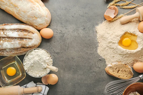 Flour with eggs and bread on grey background — Stock Photo, Image