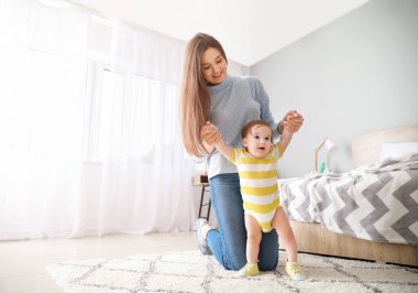 Yatak odasında sevimli erkek bebek ile Mutlu anne