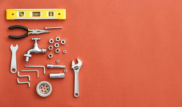 Set of plumbing tools and items on color background