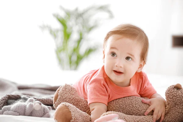 Retrato de menino adorável com brinquedo na cama em casa — Fotografia de Stock