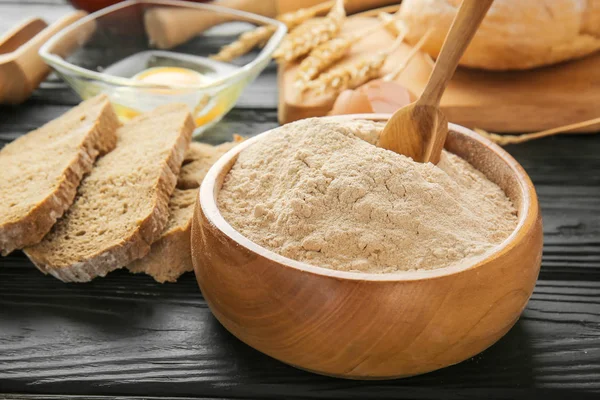 Bowl with flour on dark table — Stock Photo, Image